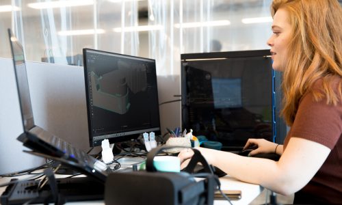 woman at a computer creating vr tech content