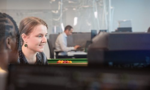 two young women coding at a computer