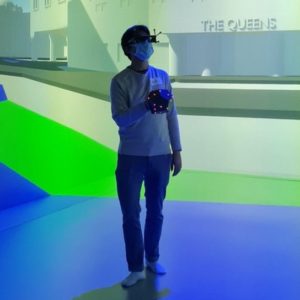 Man in an immersive VR cave environment with VR headset on.