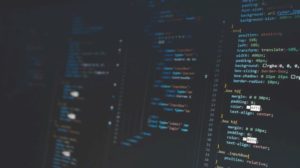 coding script on a dark laptop